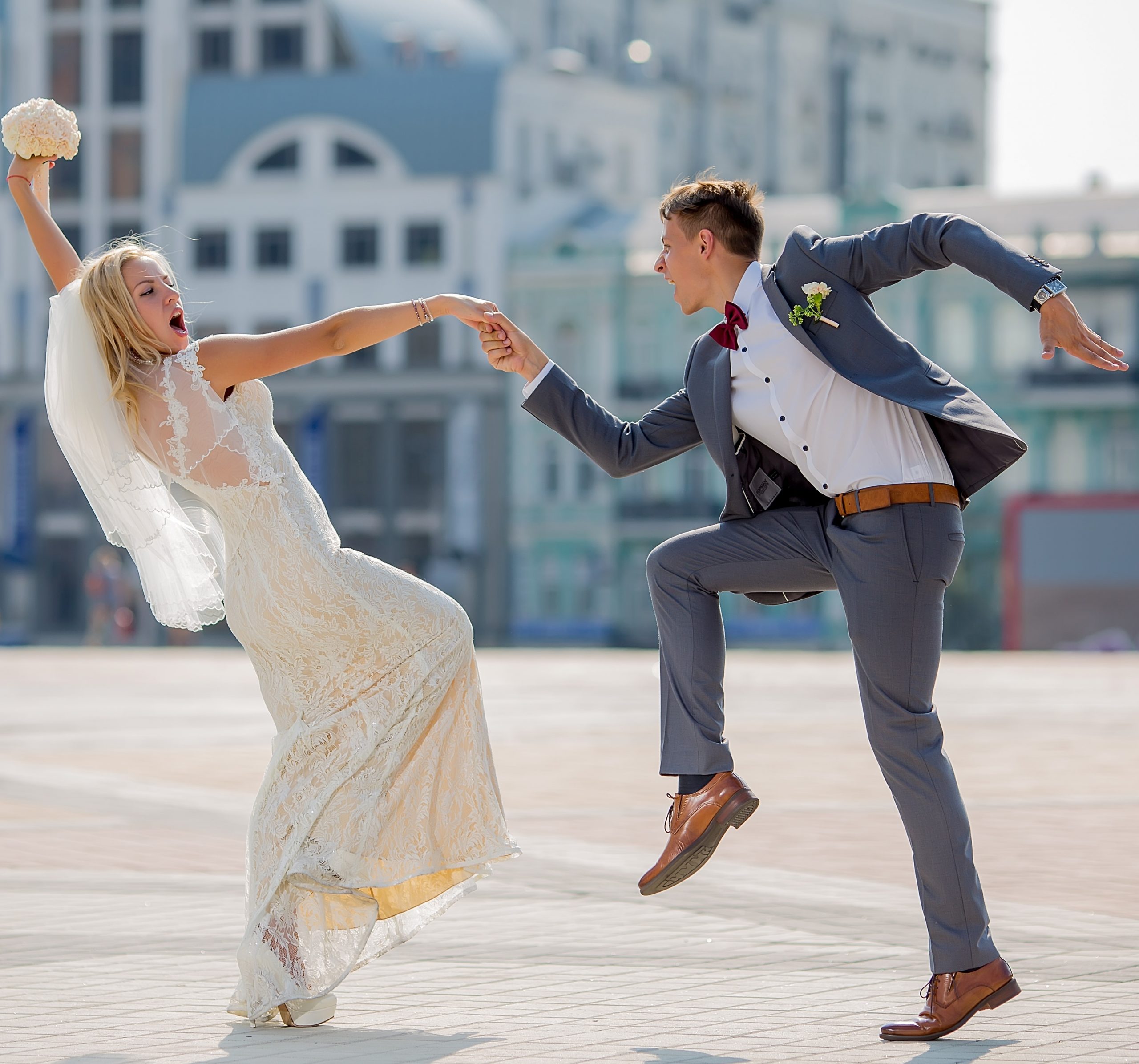 bride and groom in wedding attire dancing
